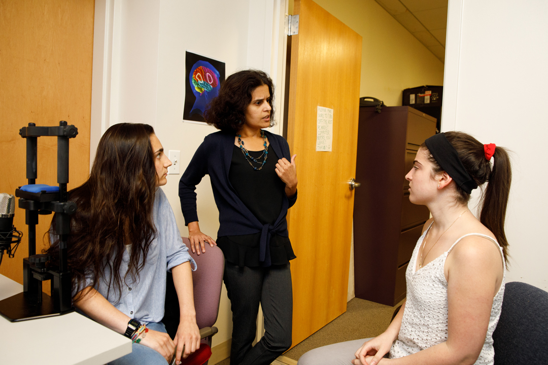 Malathi Thothathiri (center) with student researchers Maria Braiuca (left) and Kasey Lerner (right)